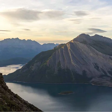 Norwegian fjord landscape with mountain peaks at sunset.